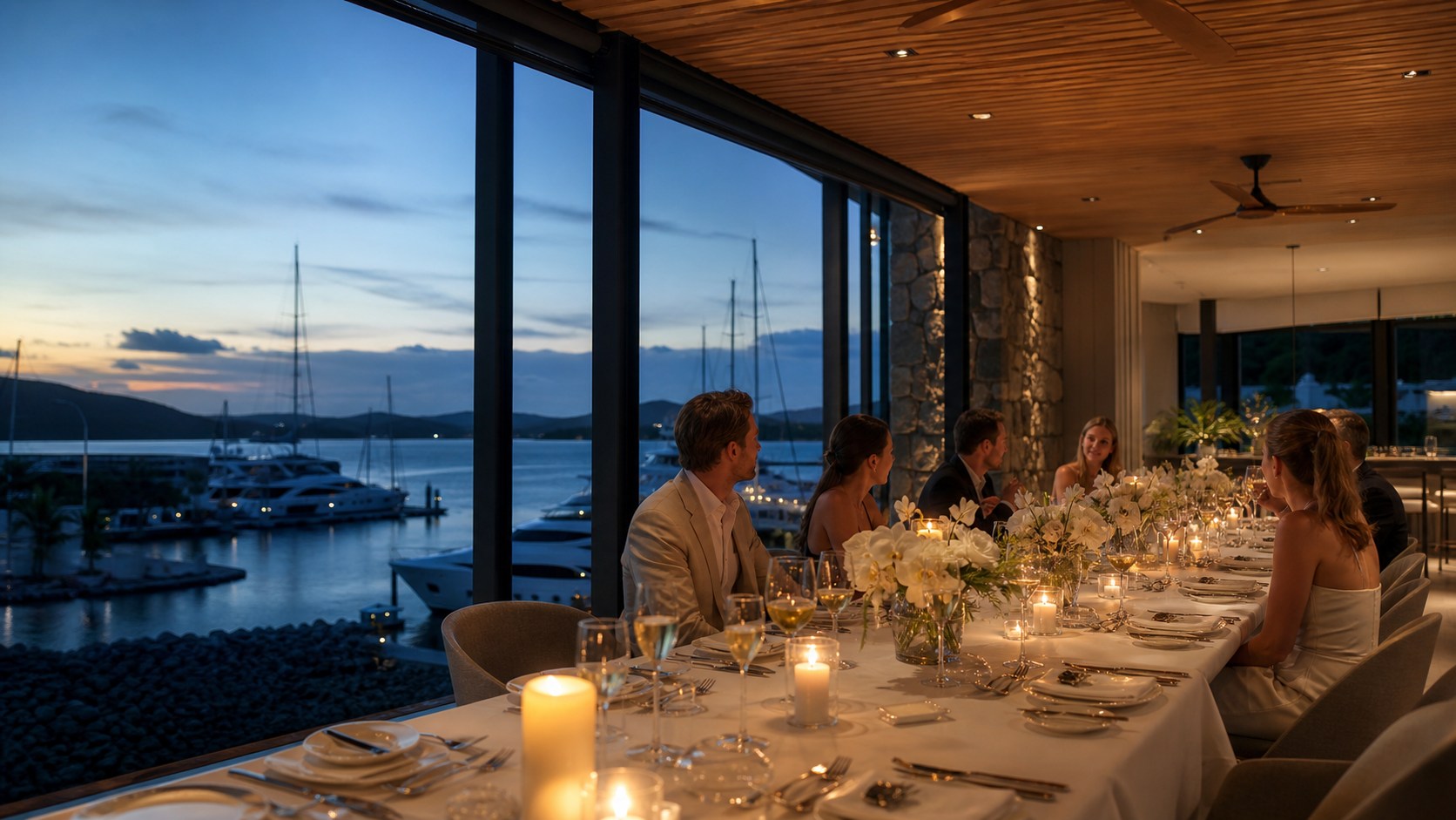 A private waterfront dinner overlooking the marina at blue hour